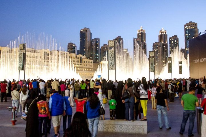 Experience the dazzling fountain show against Dubai's stunning skyline where families gather to create unforgettable memories during a delightful city tour. Adventure awaits every traveler!